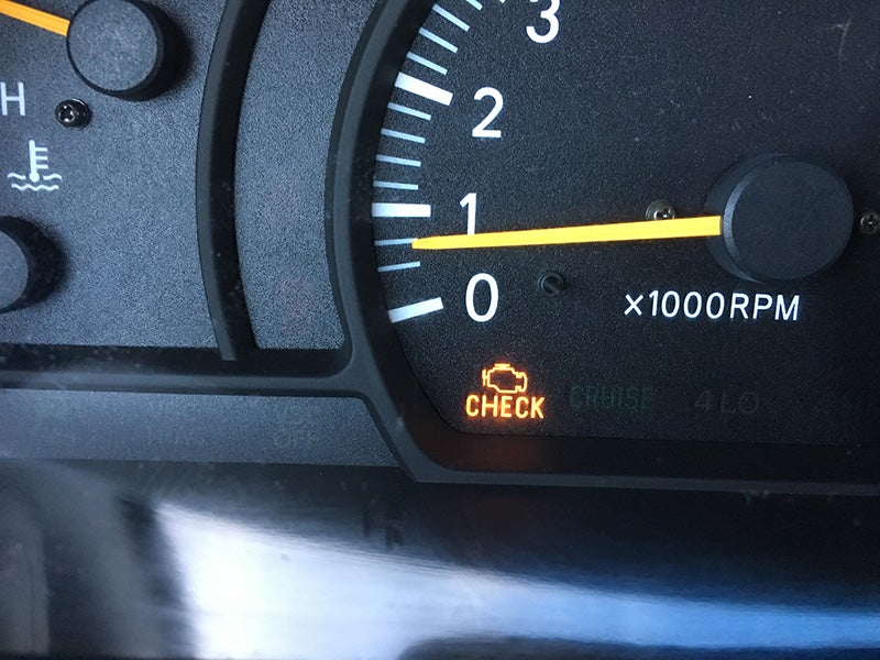 A dashboard showing a check engine light